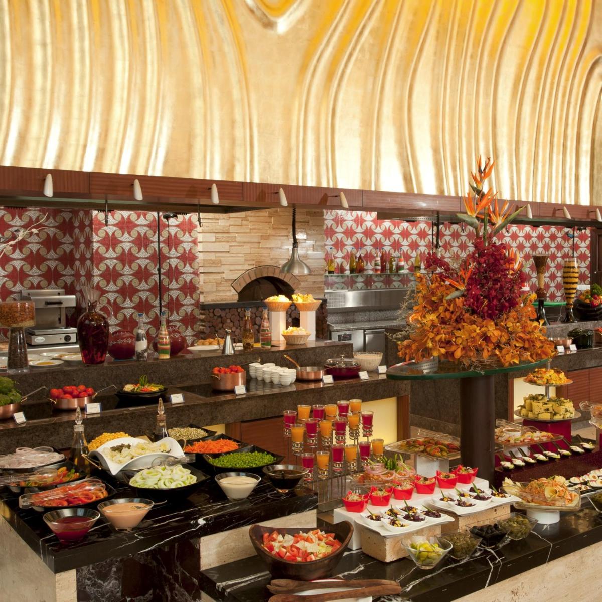 a buffet line with many different types of food at Radisson Blu Hotel, Nagpur in Nagpur