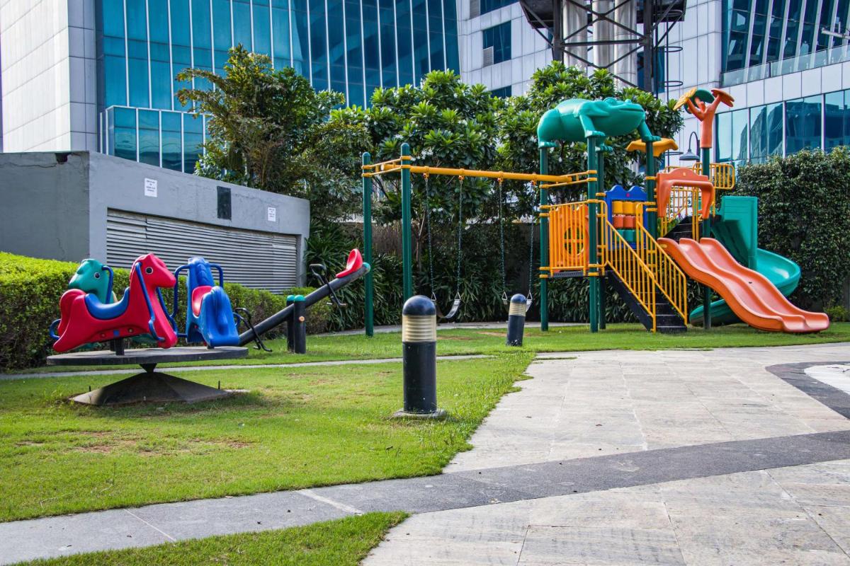 a playground with a slide in a park at Hyatt Regency Gurgaon in Gurgaon