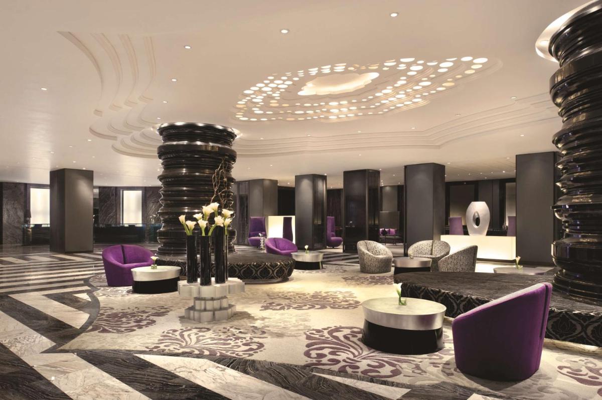 a lobby with purple furniture and a chandelier at Hyatt Regency Gurgaon in Gurgaon