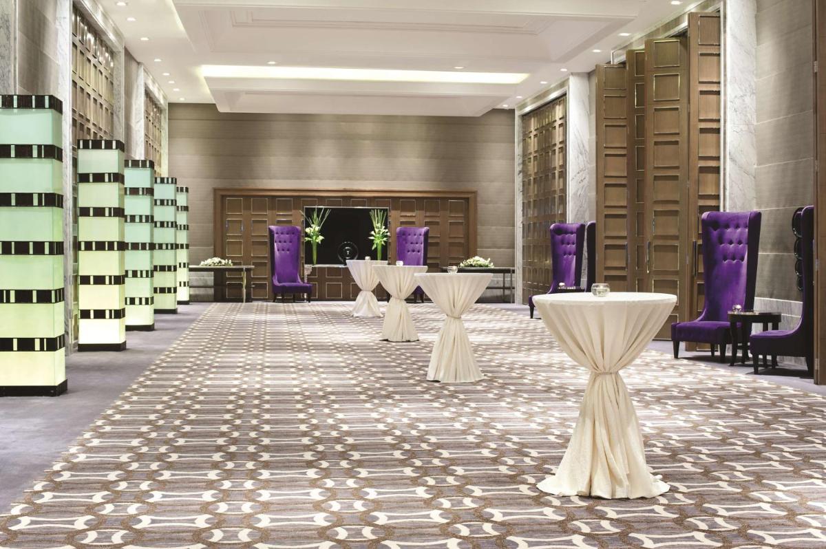 a row of tables in a library with purple chairs at Hyatt Regency Gurgaon in Gurgaon