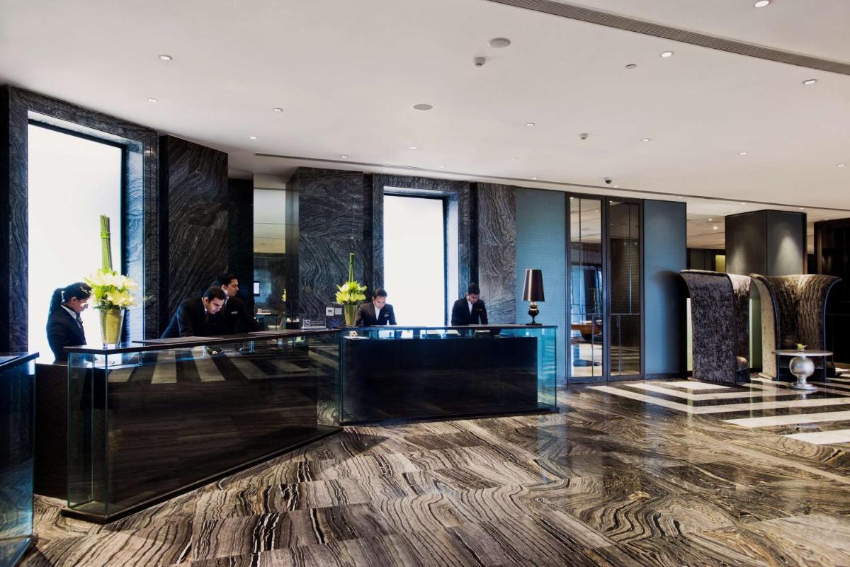 a lobby of a hotel with a reception desk at Hyatt Regency Gurgaon in Gurgaon