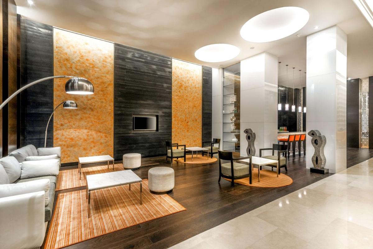 a living room with a couch and a table at Hyatt Place Gurgaon Udyog Vihar in Gurgaon