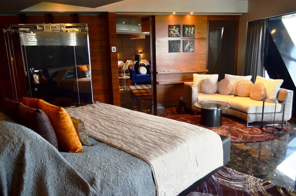 a bedroom with a bed and a couch in a room at The Park Hyderabad, Banjara Hills near Hussain Sagar Lake in Hyderabad a bedroom with a bed and a couch in a room at The Park Hyderabad, Banjara Hills near Hussain Sagar Lake in Hyderabad