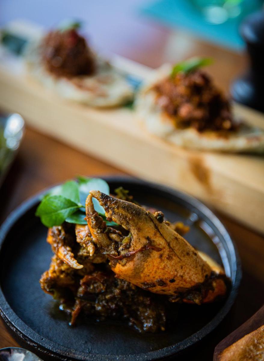 a plate with a piece of food on a table at Holiday Inn Goa Candolim in Candolim a plate with a piece of food on a table at Holiday Inn Goa Candolim in Candolim