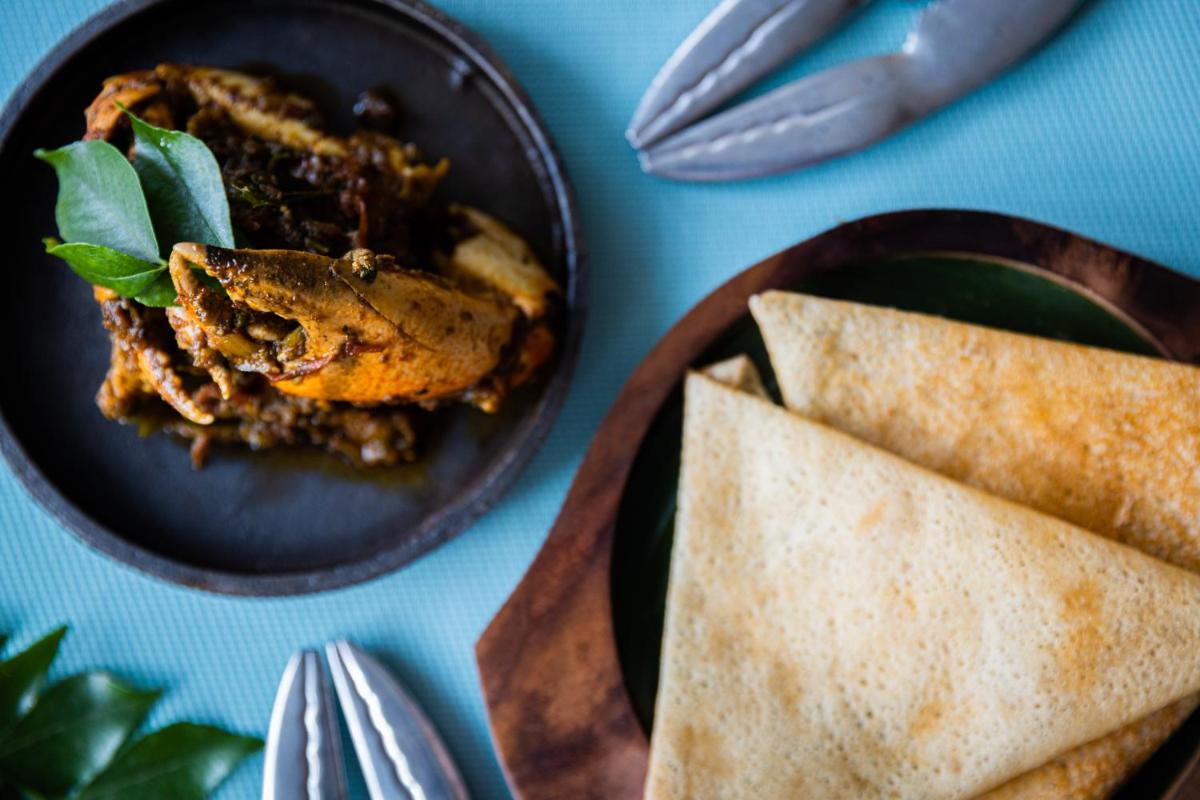 a plate of food on a table with a plate of food at Holiday Inn Goa Candolim in Candolim a plate of food on a table with a plate of food at Holiday Inn Goa Candolim in Candolim