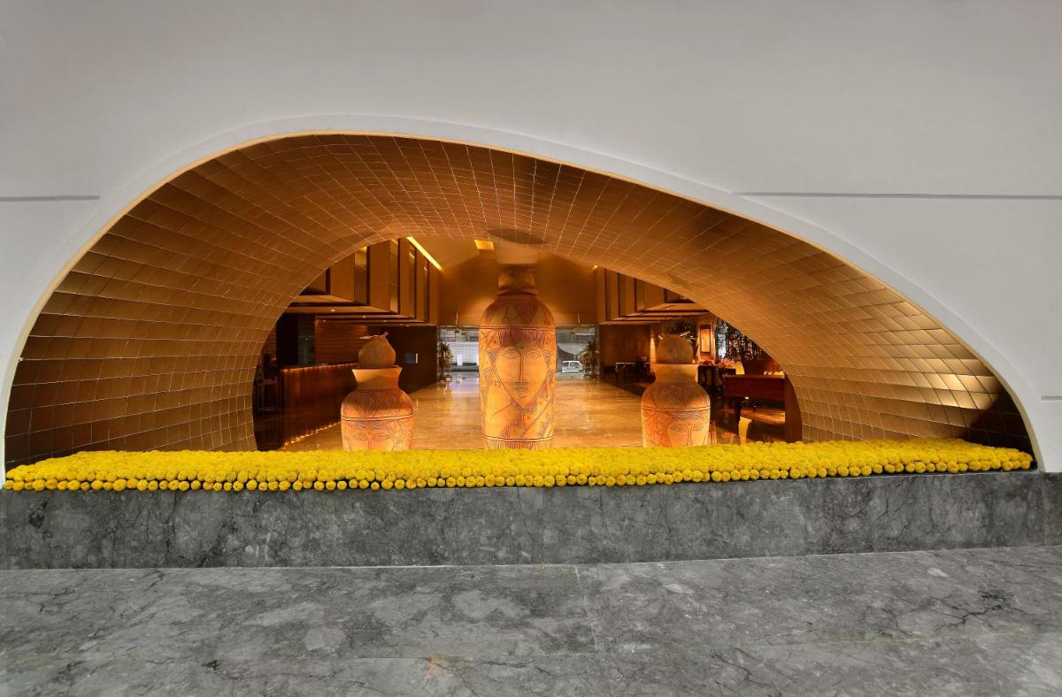 a building with an archway with yellow flowers in it at The Lalit Great Eastern Kolkata in Kolkata a building with an archway with yellow flowers in it at The Lalit Great Eastern Kolkata in Kolkata