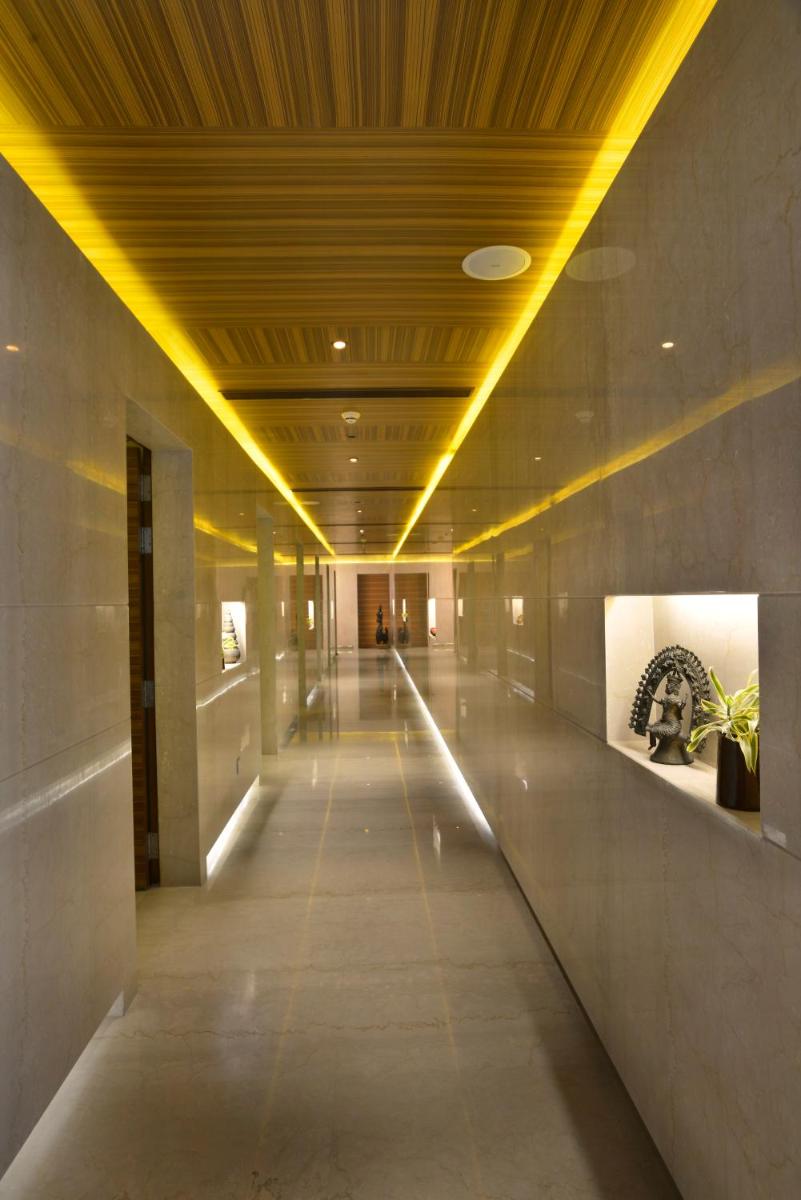 a hallway in a building with lights on the ceiling at The Lalit Great Eastern Kolkata in Kolkata a hallway in a building with lights on the ceiling at The Lalit Great Eastern Kolkata in Kolkata
