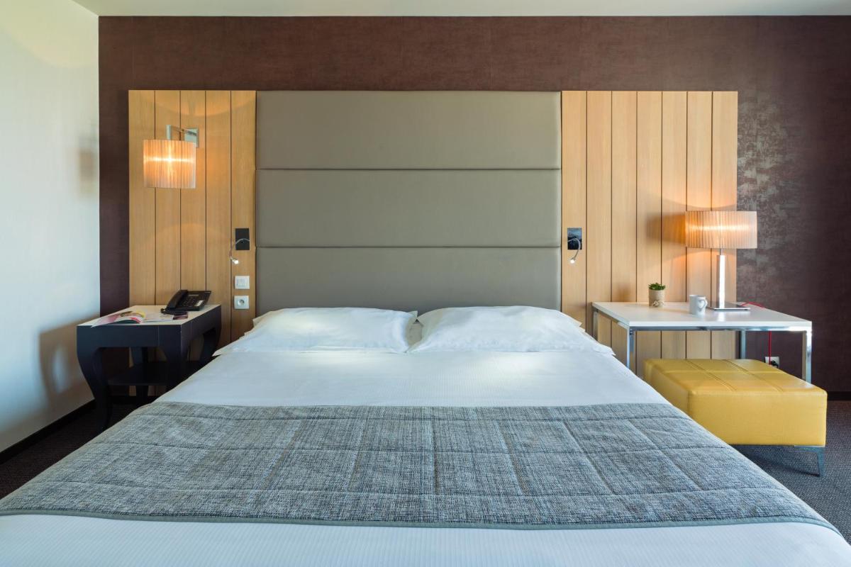 Un ou plusieurs lits dans un hébergement de l'établissement Thalasso Concarneau Spa Marin Resort