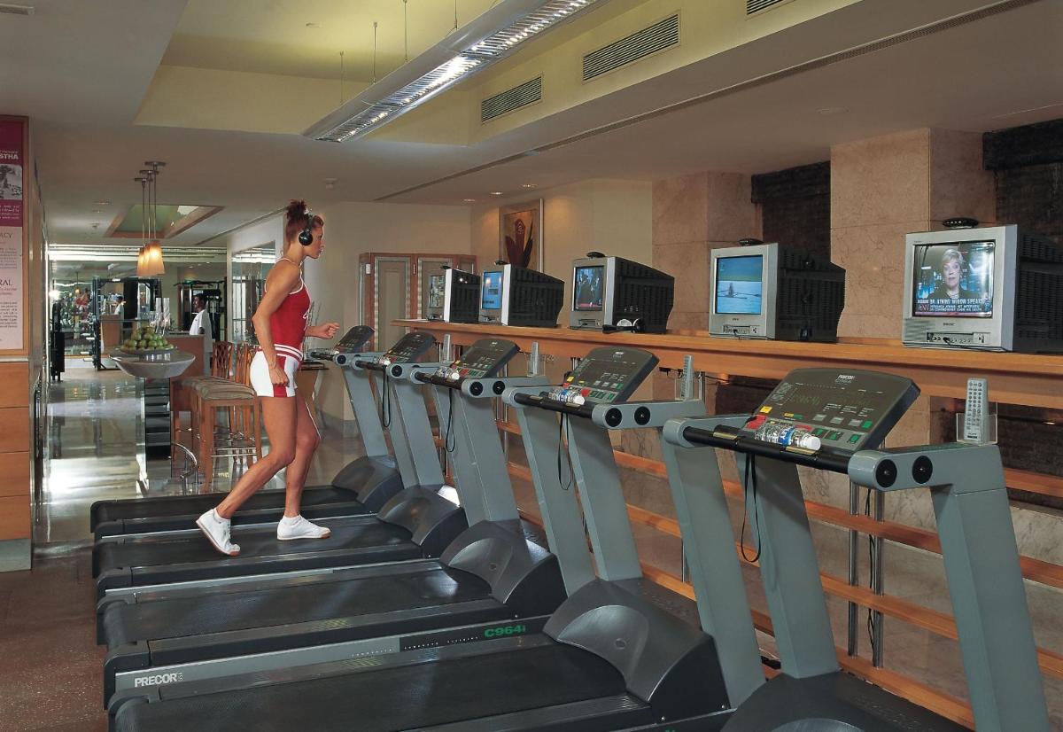 a woman walking on a treadmill in a gym at The Leela Palace Bengaluru in Bengaluru a woman walking on a treadmill in a gym at The Leela Palace Bengaluru in Bengaluru