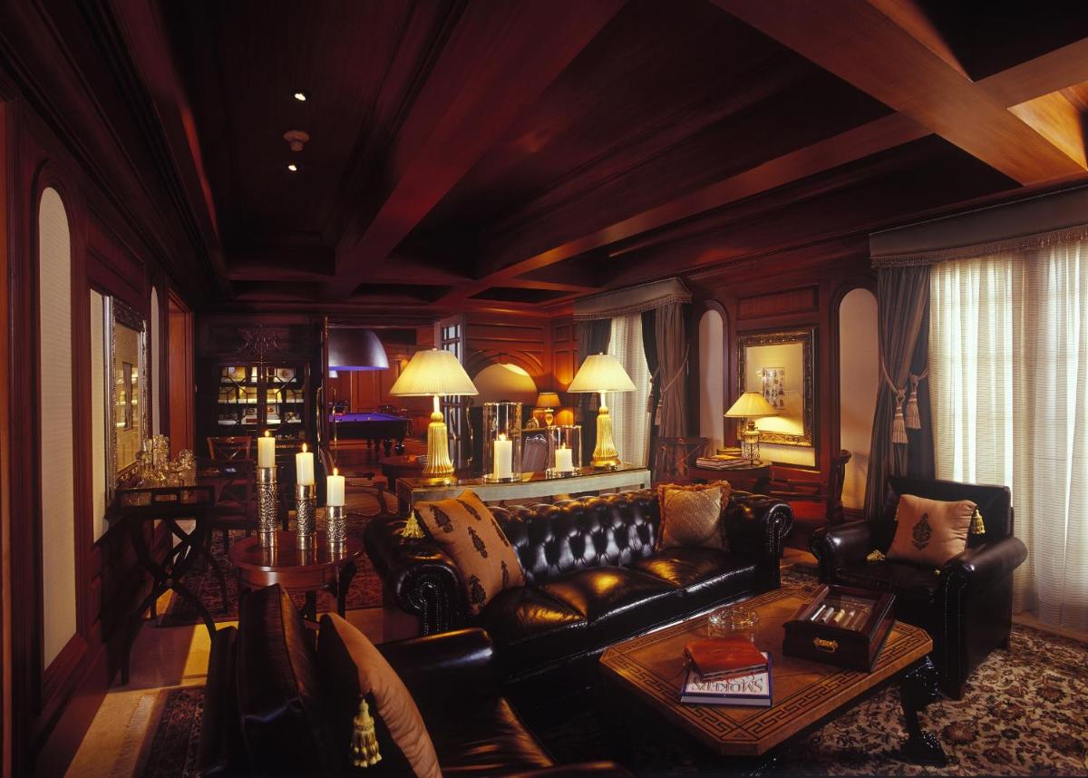 a living room with a couch and a table at The Leela Palace Bengaluru in Bengaluru a living room with a couch and a table at The Leela Palace Bengaluru in Bengaluru