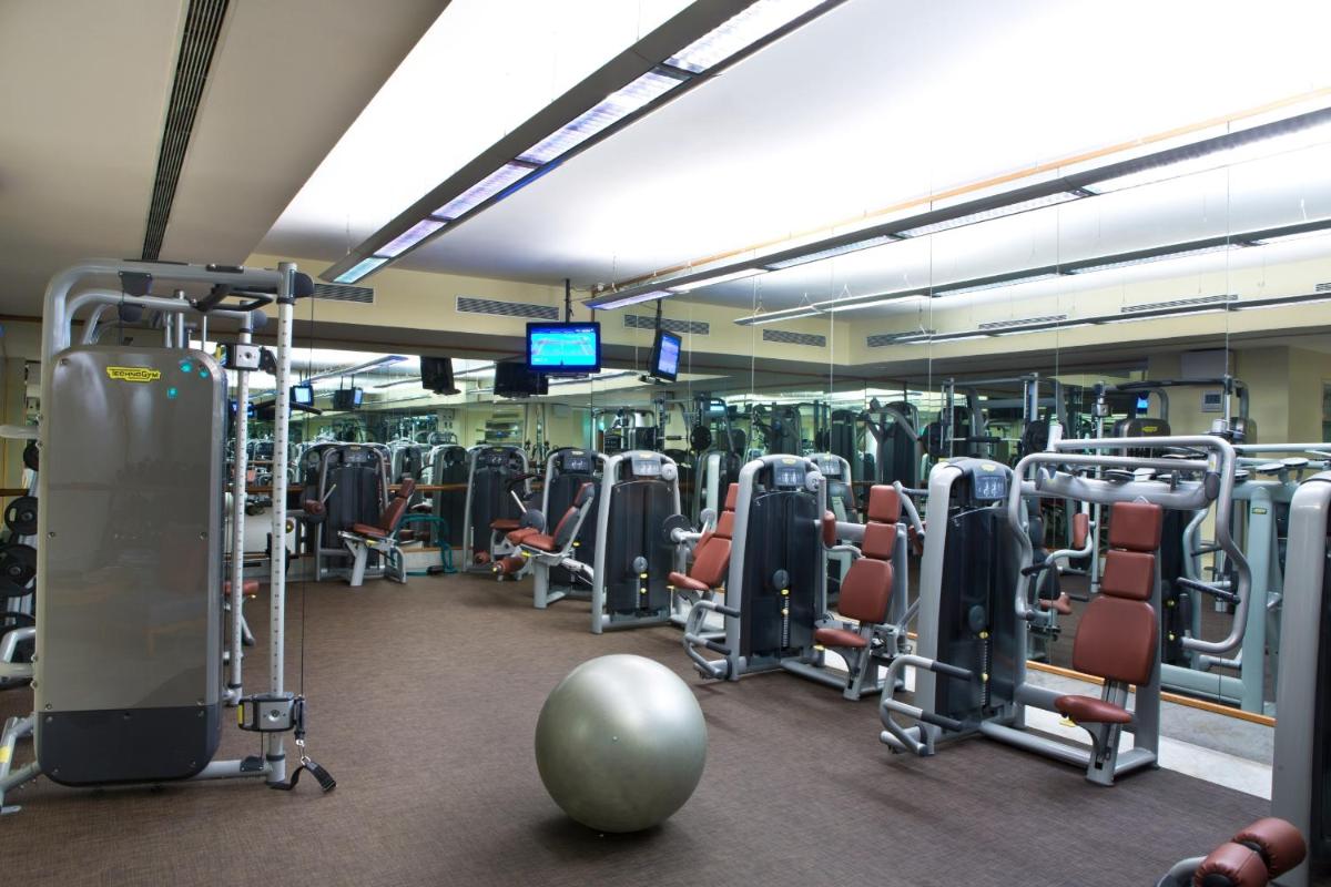 a gym with a bunch of exercise equipment in it at The Leela Palace Bengaluru in Bengaluru a gym with a bunch of exercise equipment in it at The Leela Palace Bengaluru in Bengaluru