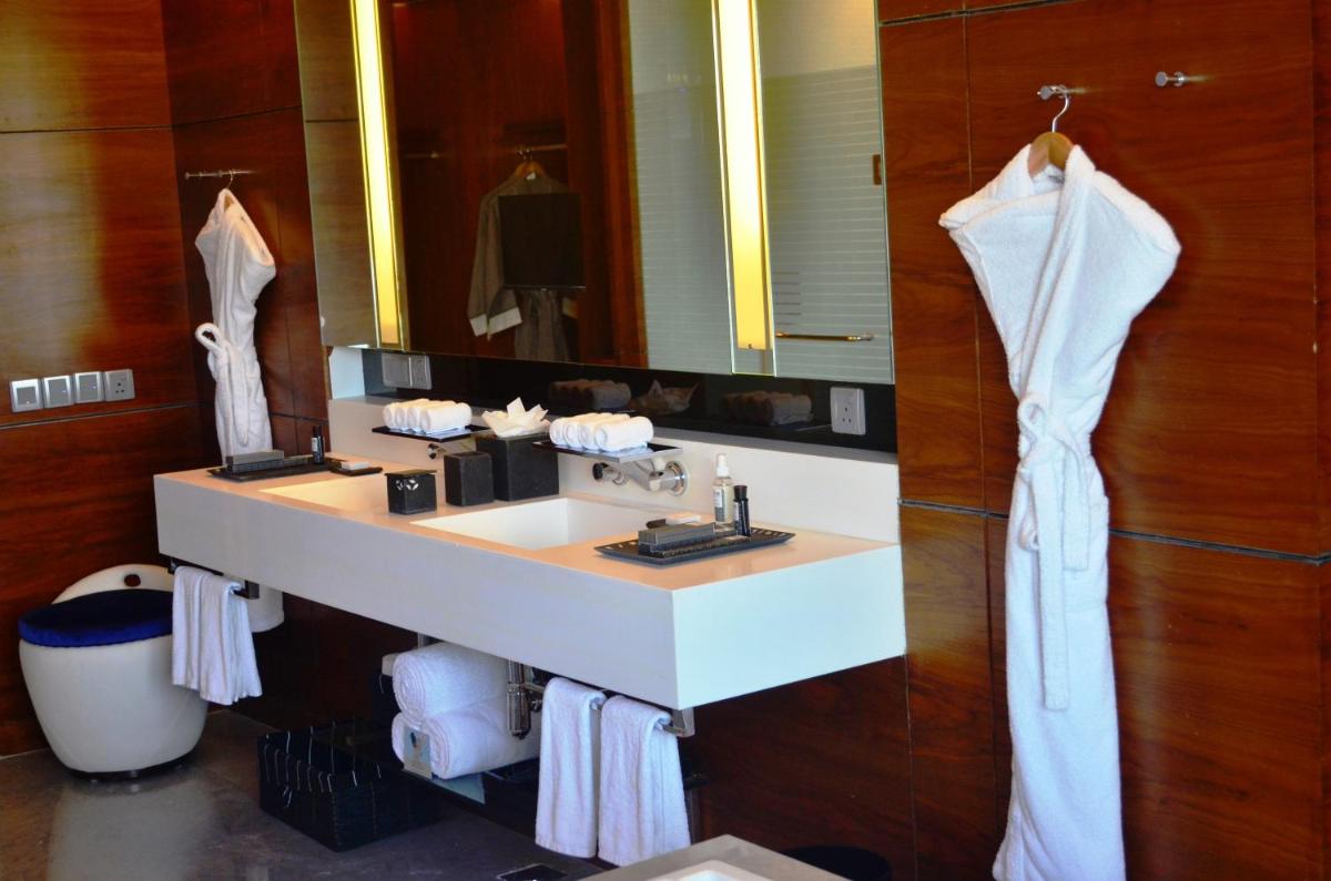 a bathroom with a white sink and a mirror at The Park Hyderabad, Banjara Hills near Hussain Sagar Lake in Hyderabad a bathroom with a white sink and a mirror at The Park Hyderabad, Banjara Hills near Hussain Sagar Lake in Hyderabad