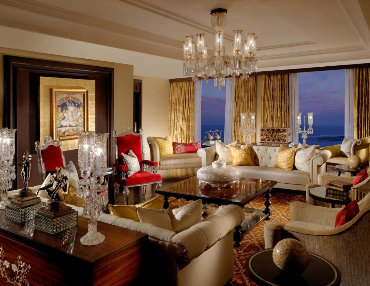 a living room with couches and a chandelier at The Leela Palace Chennai in Chennai a living room with couches and a chandelier at The Leela Palace Chennai in Chennai