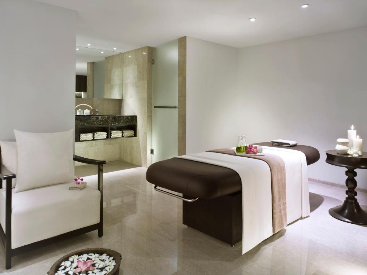 a bedroom with a bed and a chair in a room at Vivanta Chennai IT Expressway OMR in Chennai
