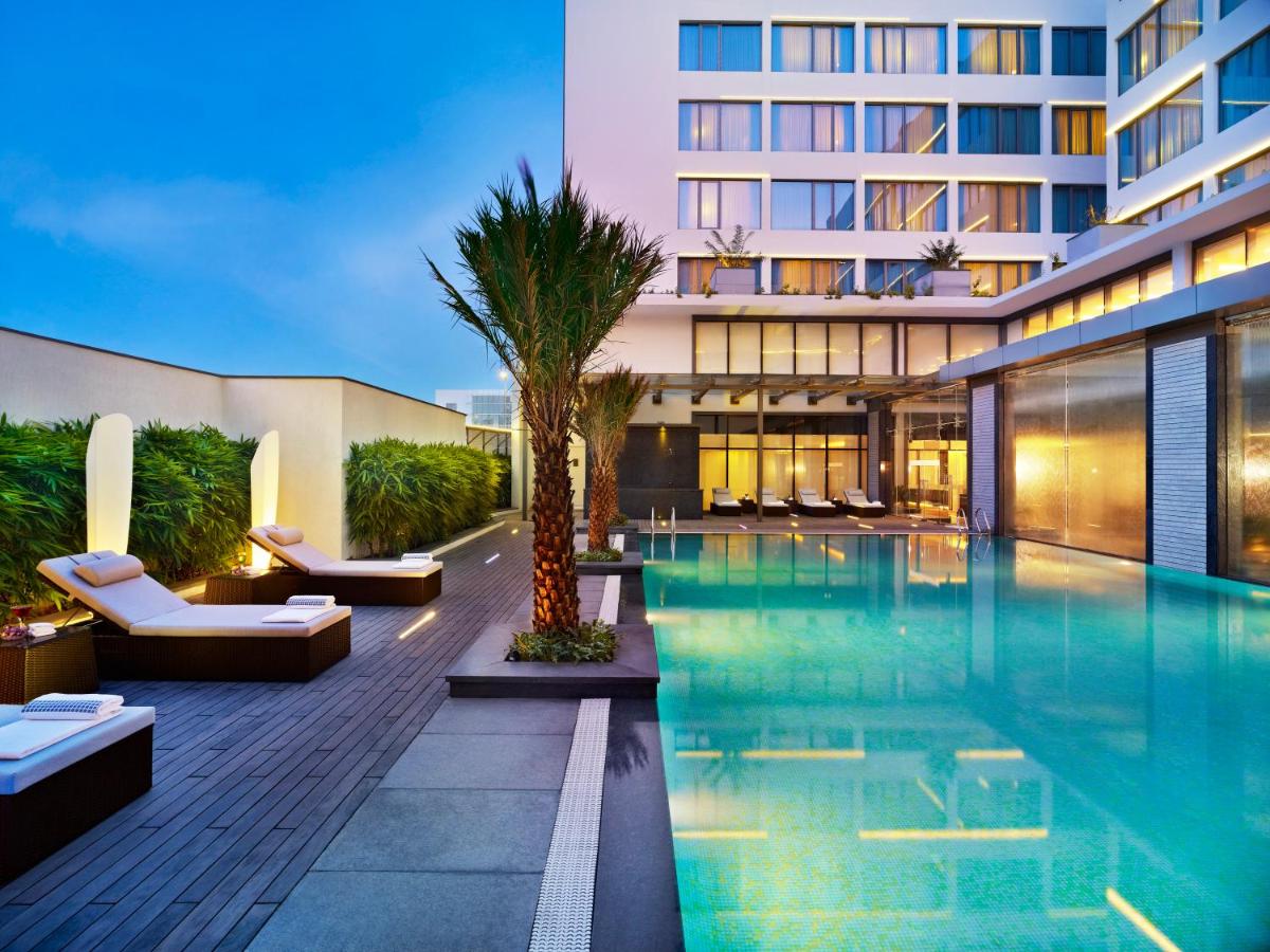 a hotel with a swimming pool and a building at Vivanta Chennai IT Expressway OMR in Chennai