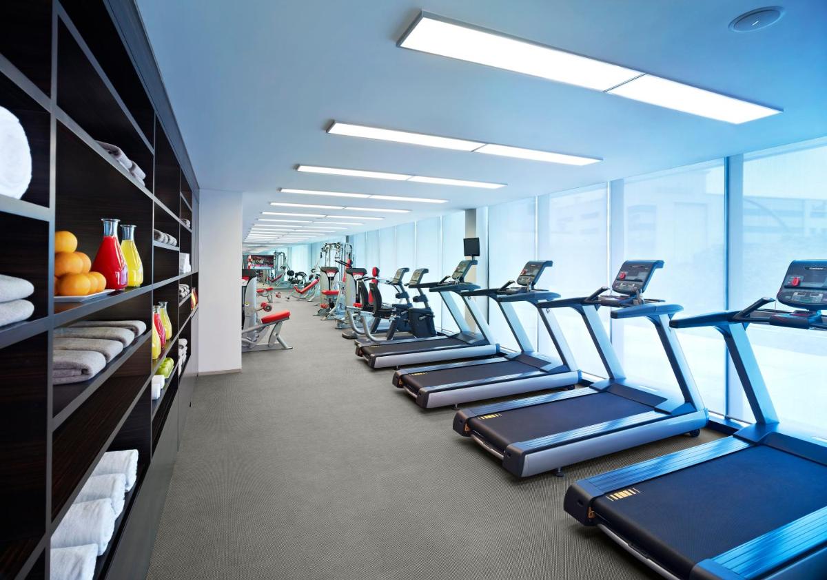a row of treadmills in an office building with at Vivanta Chennai IT Expressway OMR in Chennai