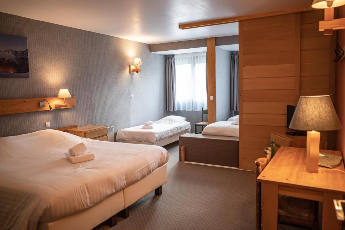 Un ou plusieurs lits dans un hébergement de l'établissement Hôtel Restaurant Saint Roch