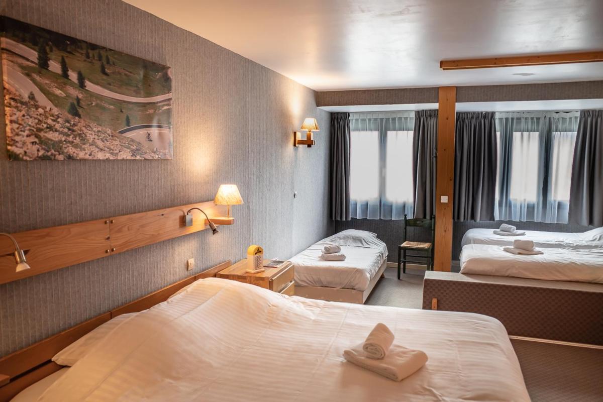 Un ou plusieurs lits dans un hébergement de l'établissement Hôtel Restaurant Saint Roch