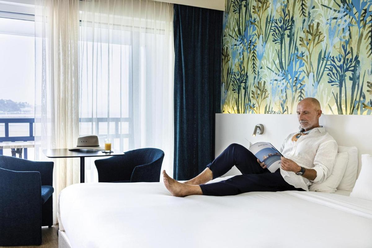 Un ou plusieurs lits dans un hébergement de l'établissement Hôtel Serge Blanco - Relais Thalasso & Spa