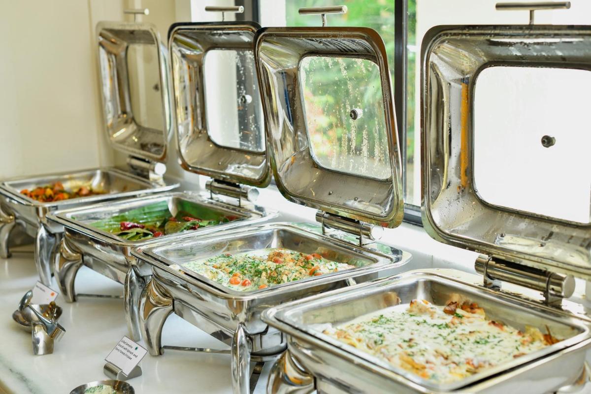 three trays of food in trays on a counter at Holiday Inn Goa Candolim in Candolim three trays of food in trays on a counter at Holiday Inn Goa Candolim in Candolim