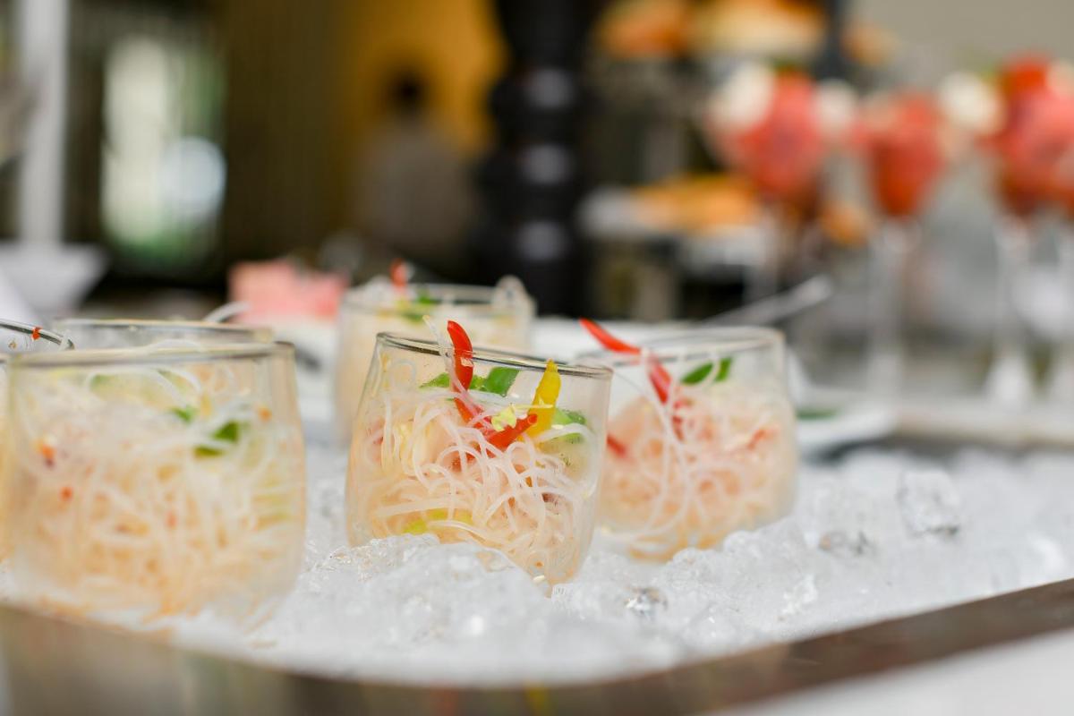 a group of glasses filled with food on top of ice at Holiday Inn Goa Candolim in Candolim a group of glasses filled with food on top of ice at Holiday Inn Goa Candolim in Candolim
