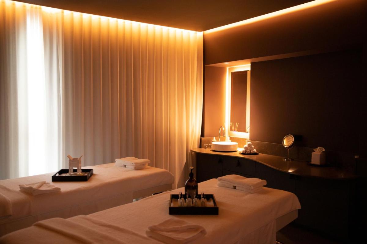 Un ou plusieurs lits dans un hébergement de l'établissement Hôtel Plage Palace & Spa