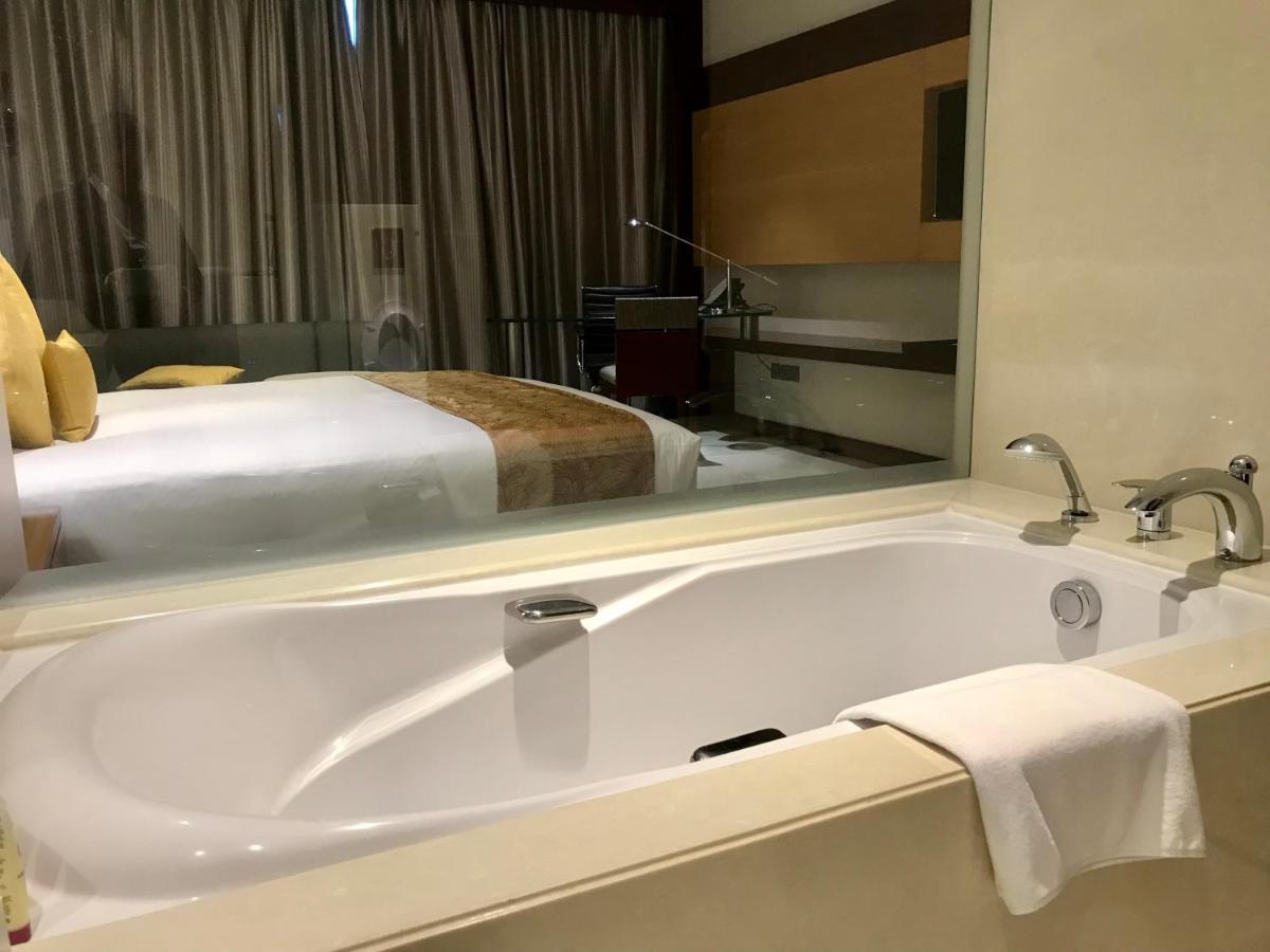 a bathroom with a large bath tub in a hotel room at Crowne Plaza Kochi by IHG in Cochin