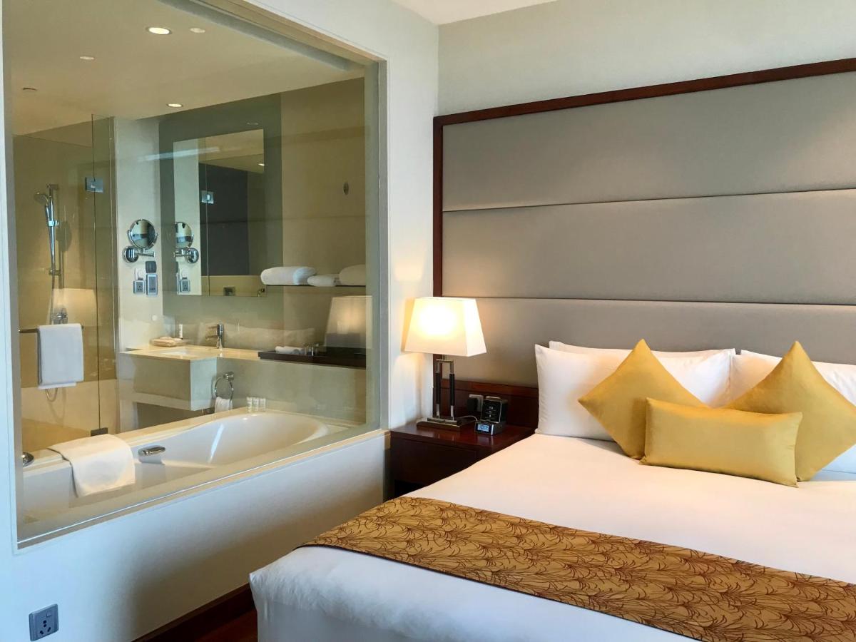 a hotel room with a bed and a bath tub at Crowne Plaza Kochi by IHG in Cochin
