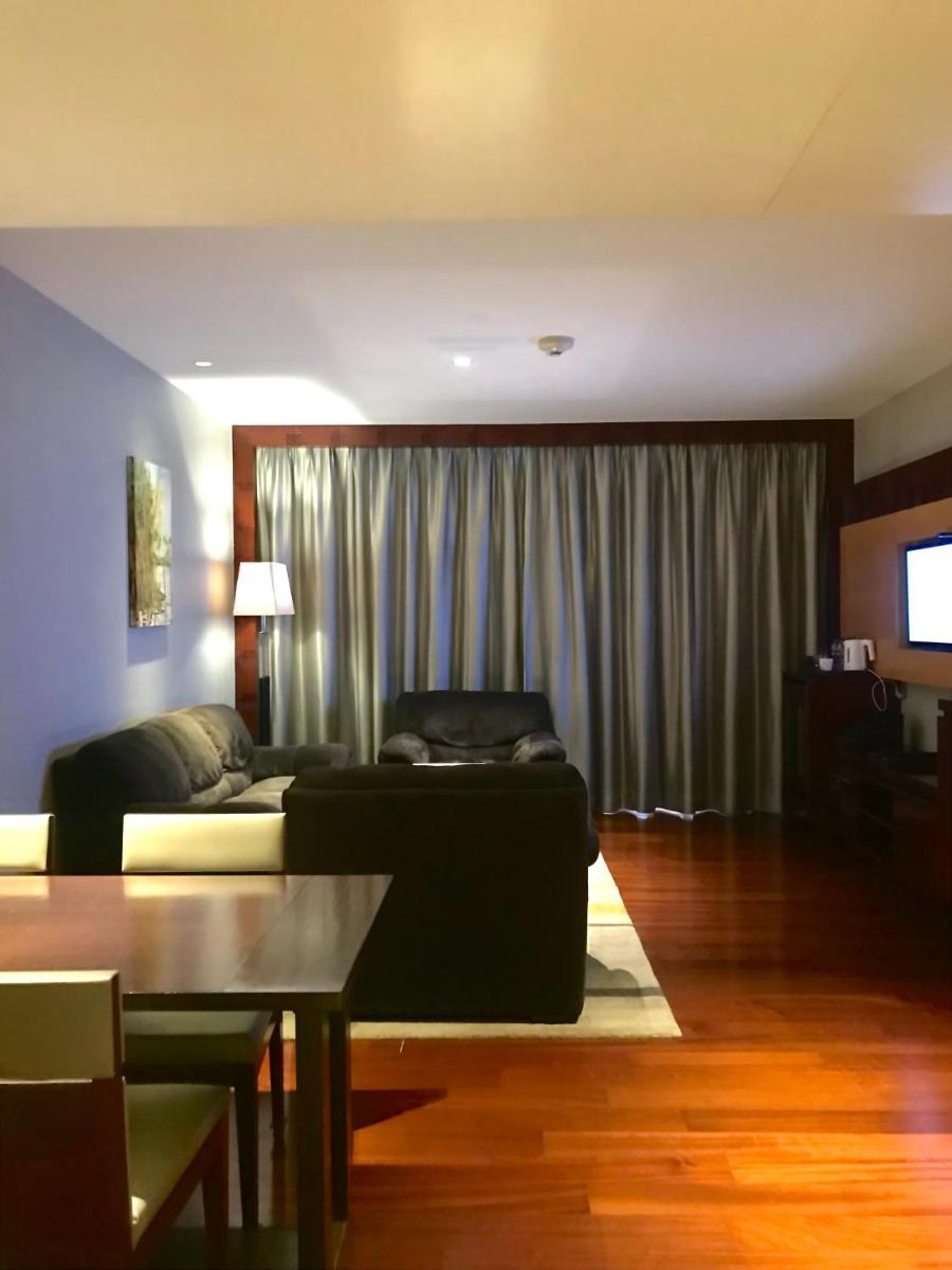 a living room with a couch and a table at Crowne Plaza Kochi by IHG in Cochin