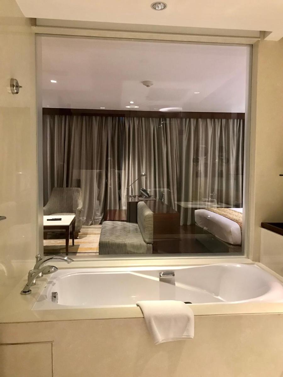 a large bathroom with a tub and a living room at Crowne Plaza Kochi by IHG in Cochin