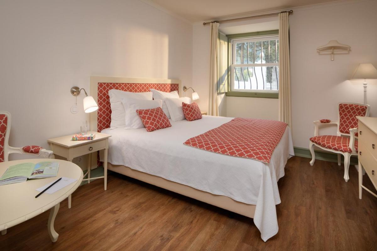 Uma cama ou camas num quarto em Hotel Casa Palmela - Small Luxury Hotels of The World, Hotel & Villas
