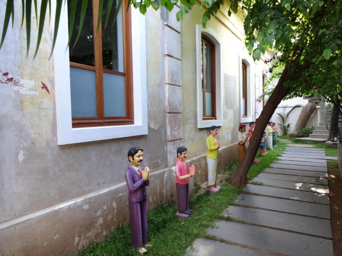a group of people standing outside of a building at La Villa in Puducherry