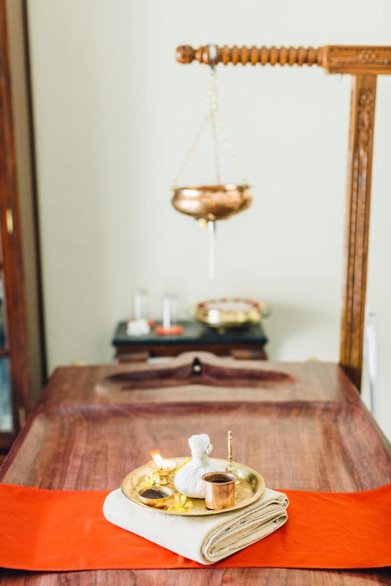 a table with a plate of food and a mirror at Royal Heritage Haveli - By Leisure Hotels in Jaipur