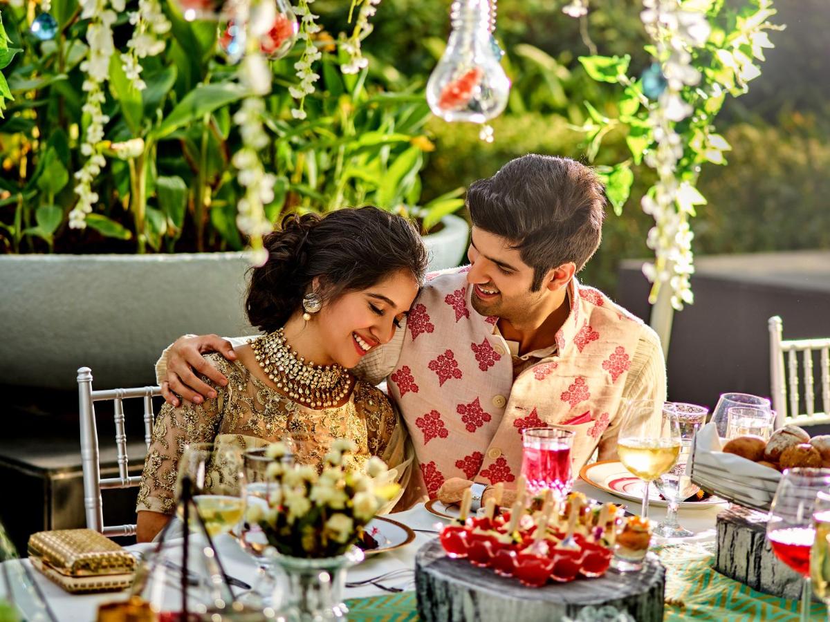 a man and a woman sitting at a table at Hyatt Place Gurgaon Udyog Vihar in Gurgaon