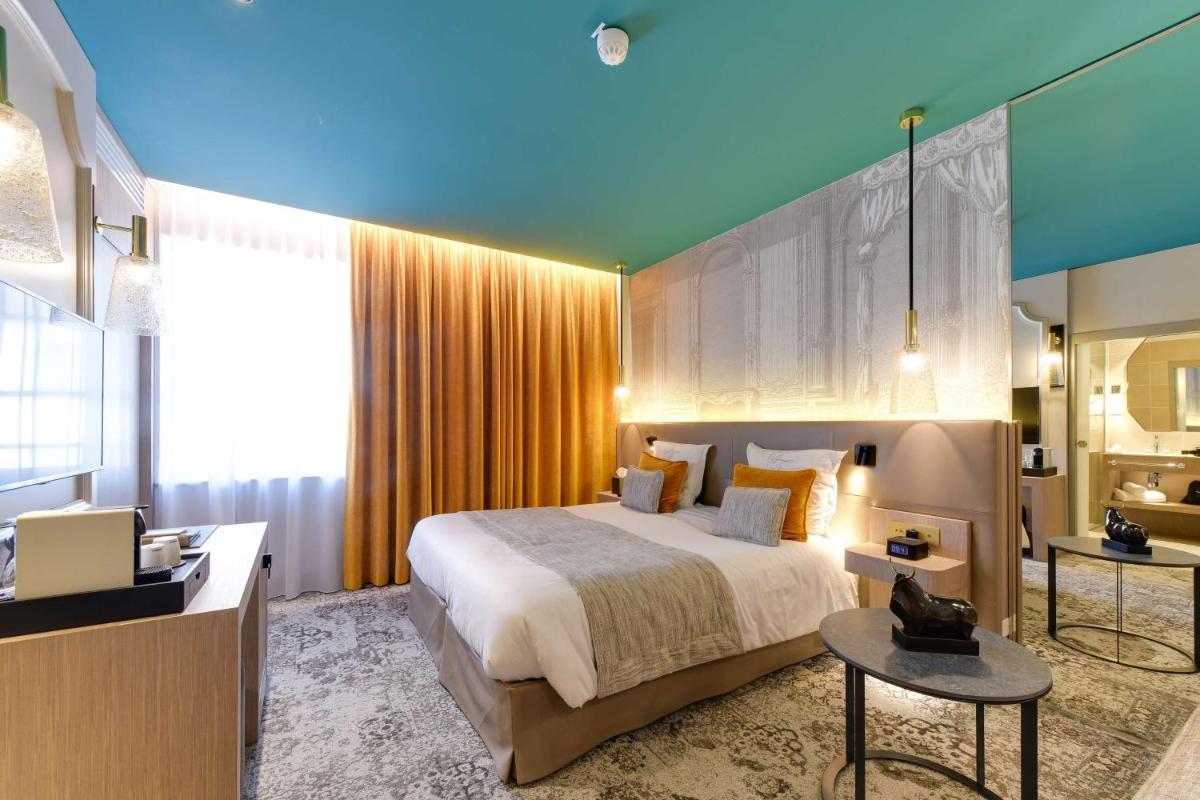 Un ou plusieurs lits dans un hébergement de l'établissement Hôtel & Spa Les Sept Fontaines Best Western Premier