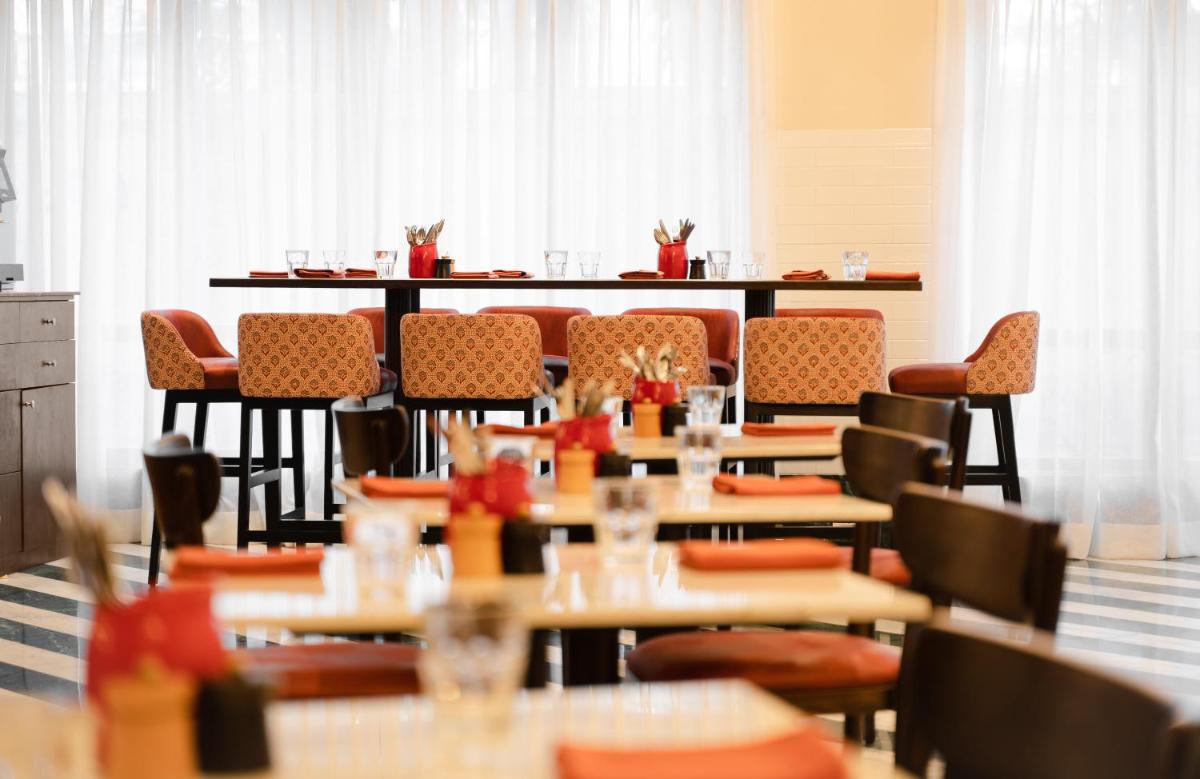 a restaurant with tables and chairs in a room at President - IHCL SeleQtions in Mumbai
