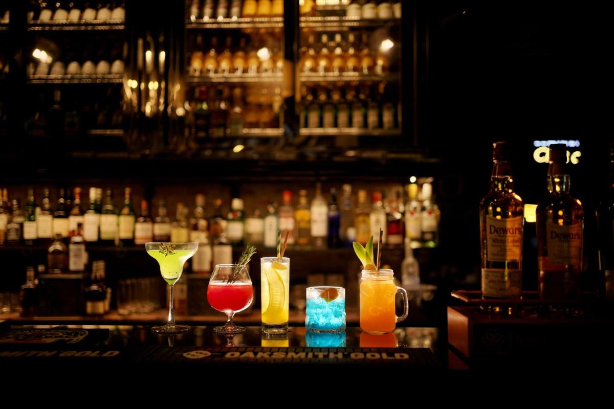 a group of drinks sitting on top of a bar at Holiday Inn Jaipur City Centre by IHG in Jaipur a group of drinks sitting on top of a bar at Holiday Inn Jaipur City Centre by IHG in Jaipur