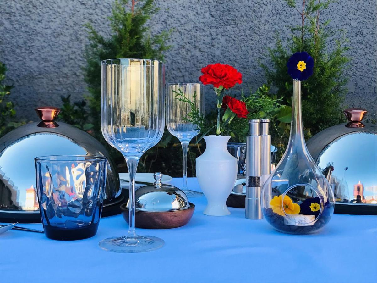 a group of wine glasses and vases on a table at Radisson Kufri in Shimla