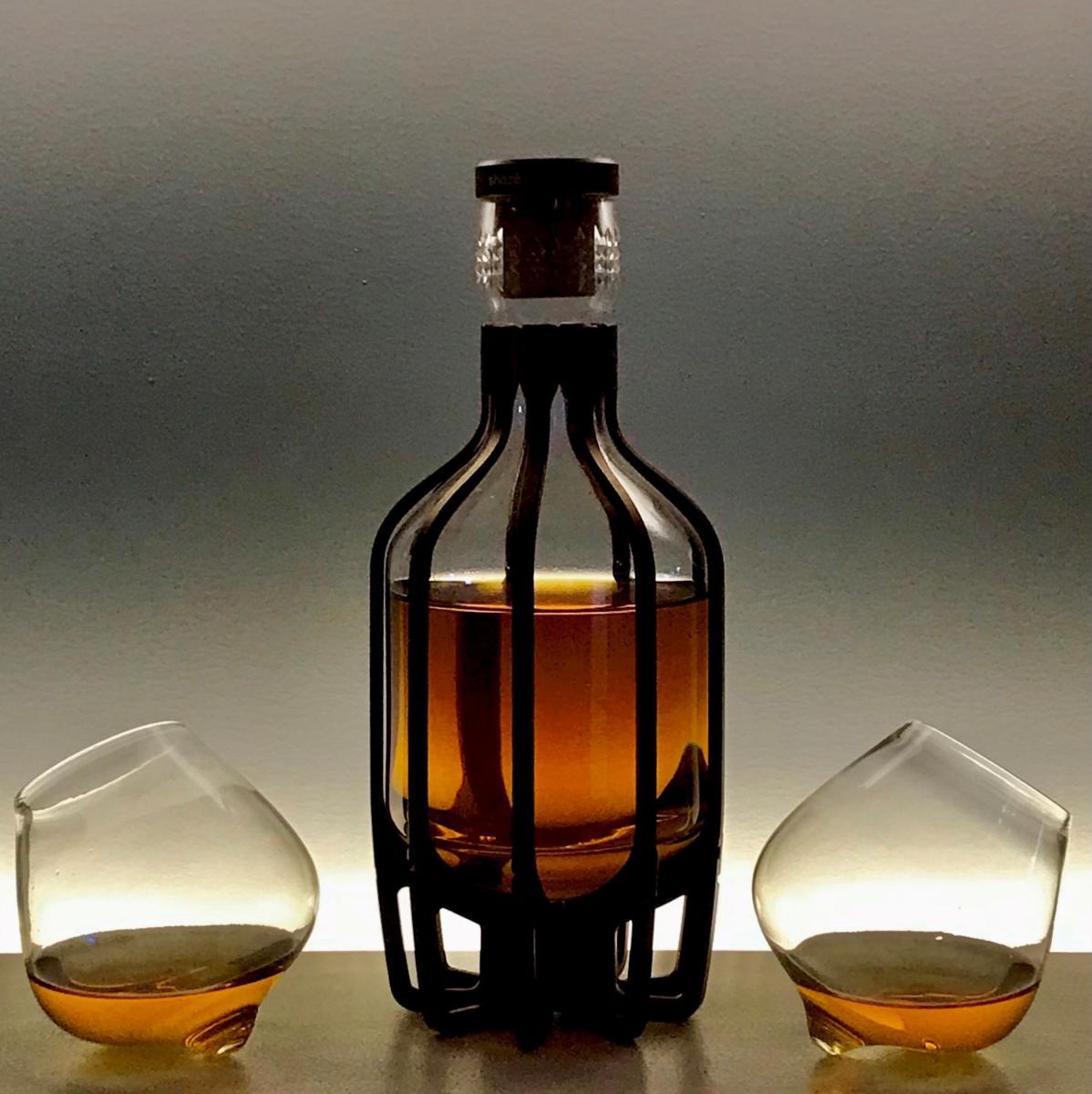 a bottle of whiskey sitting between two wine glasses at Radisson Kufri in Shimla