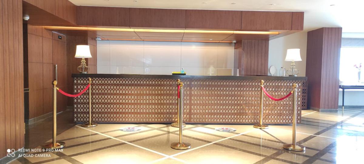 a lobby with a bar with red rope barriers at Radisson Kufri in Shimla