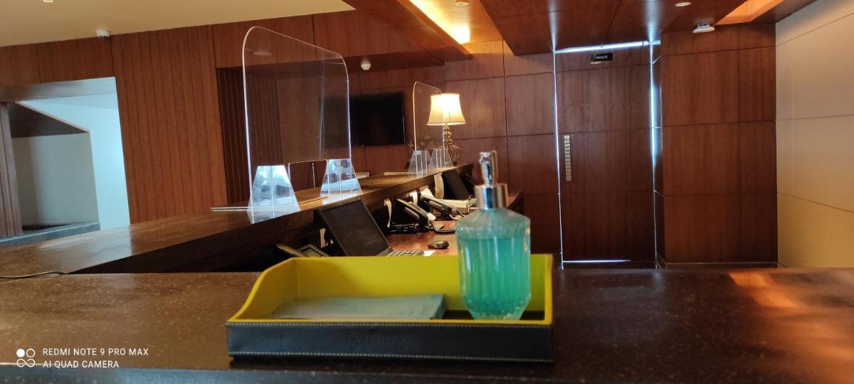 a glass bottle sitting on a counter in a room at Radisson Kufri in Shimla