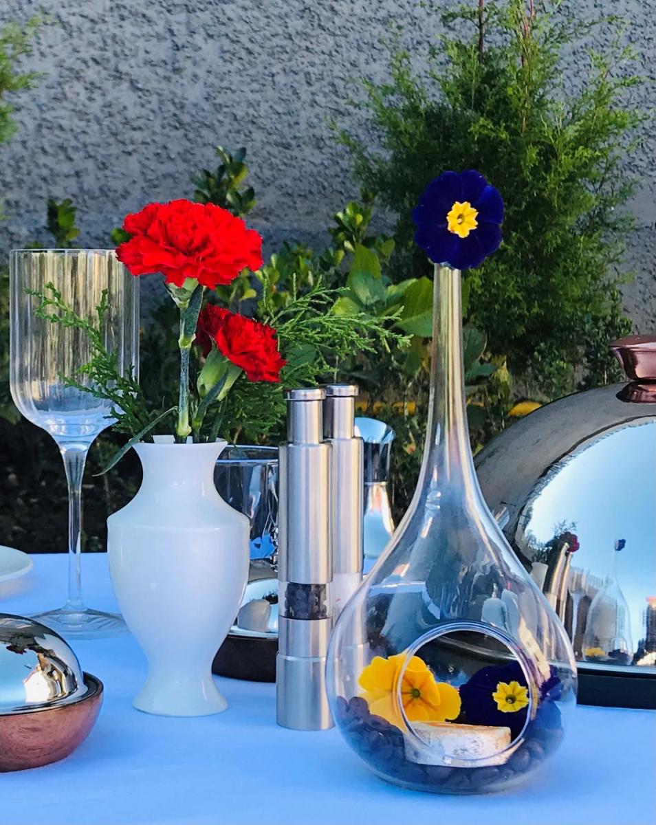 a blue vase with flowers in it sitting on a table at Radisson Kufri in Shimla