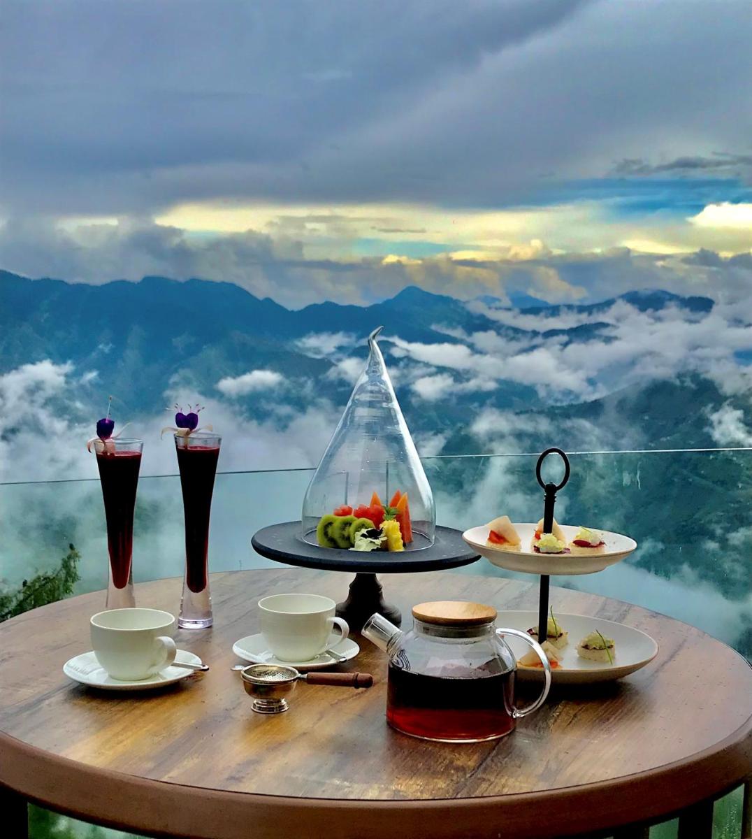 a table with food and drinks on top of a mountain at Radisson Kufri in Shimla