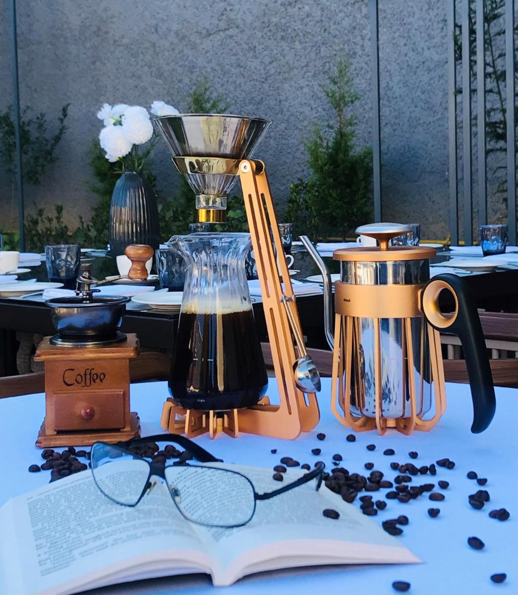an open book on a table with a blender and glasses at Radisson Kufri in Shimla
