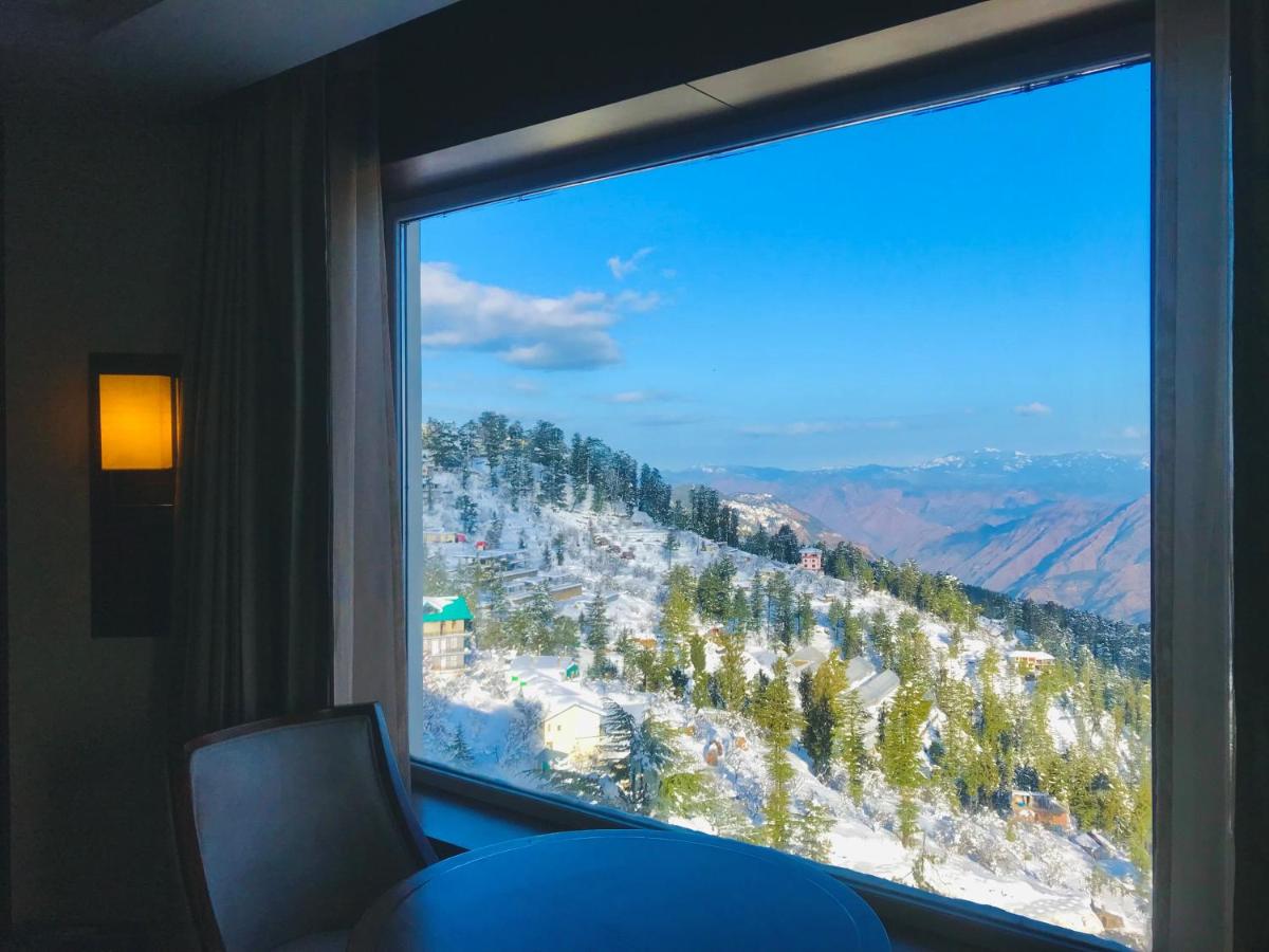 a window with a view of a mountain at Radisson Kufri in Shimla