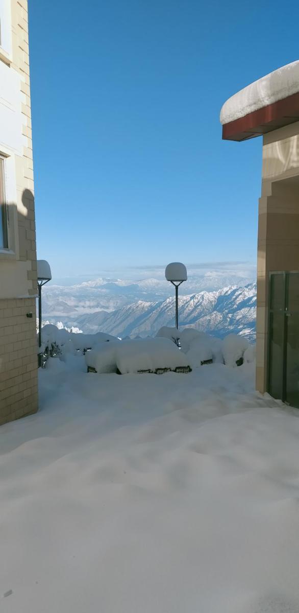a view of the mountains from the roof of a building at Radisson Kufri in Shimla
