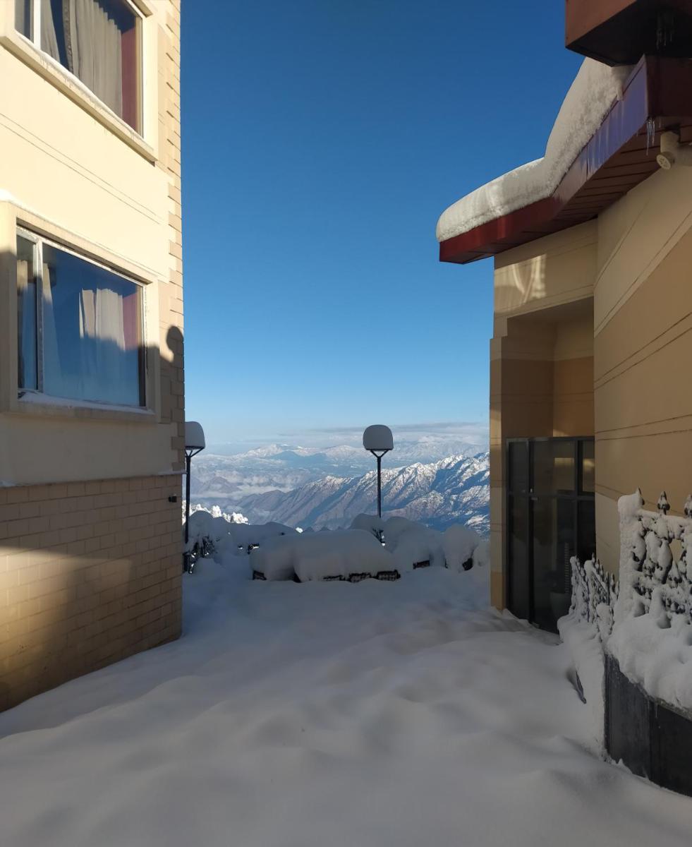 a view from a building in the snow at Radisson Kufri in Shimla