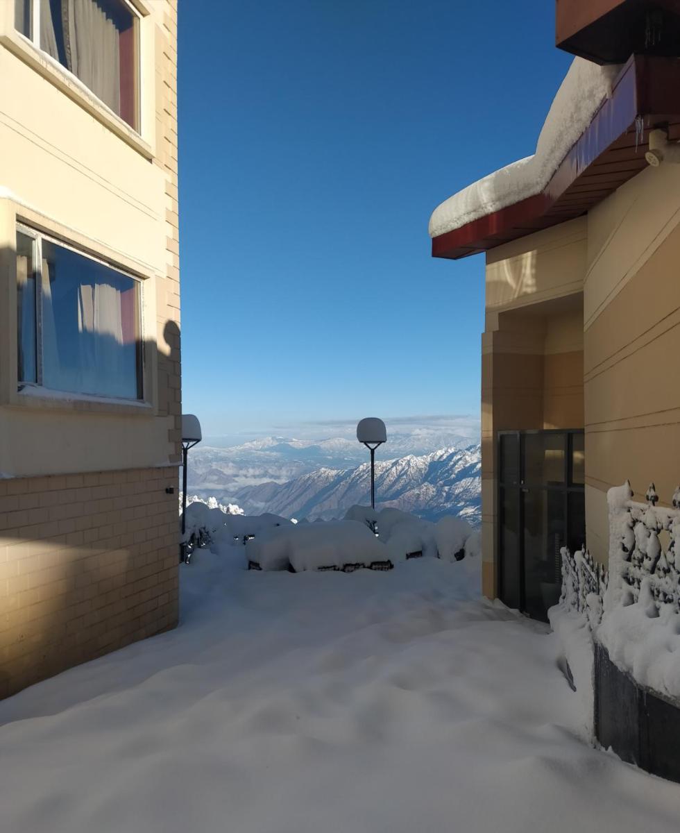 a view from a house in the snow at Radisson Kufri in Shimla