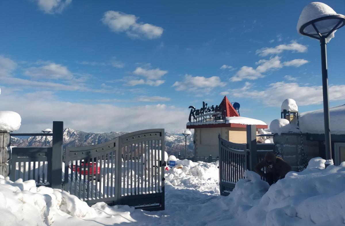 a gate covered in snow next to a street light at Radisson Kufri in Shimla