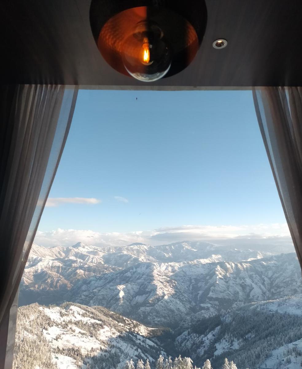 a view from an airplane window of mountains at Radisson Kufri in Shimla